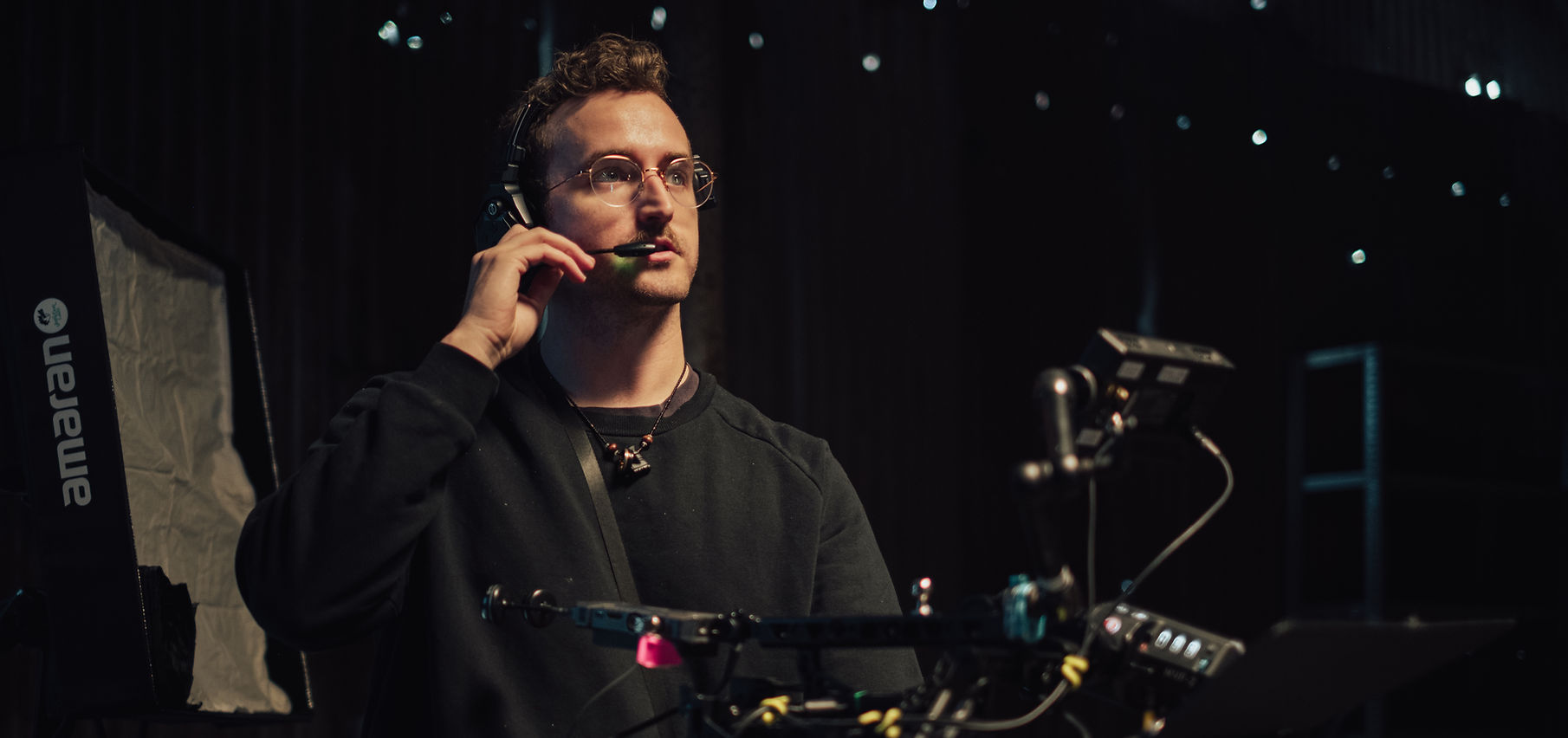 Jon Bass working on set with a headset